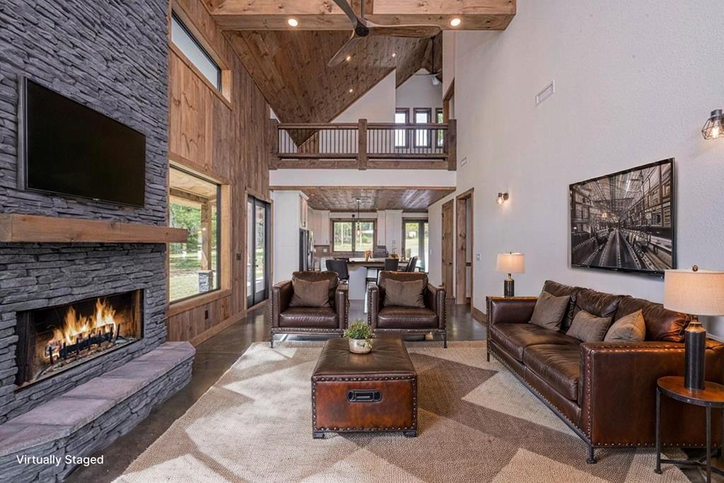 86 Valley Lake Road Mineral Bluff, GA 30559 - Photo 59 of 59 a living room with furniture a flat screen tv and a fireplace