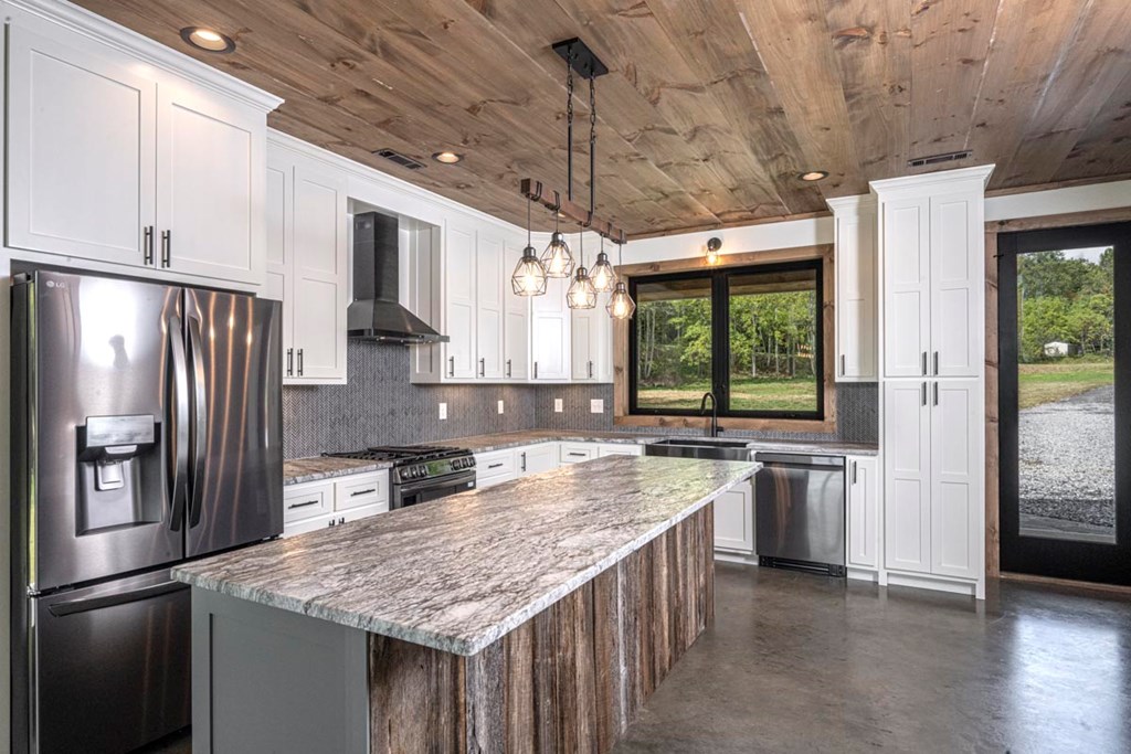 86 Valley Lake Road Mineral Bluff, GA 30559 - Photo 8 of 59 a kitchen with stainless steel appliances granite countertop a refrigerator a sink and a stove