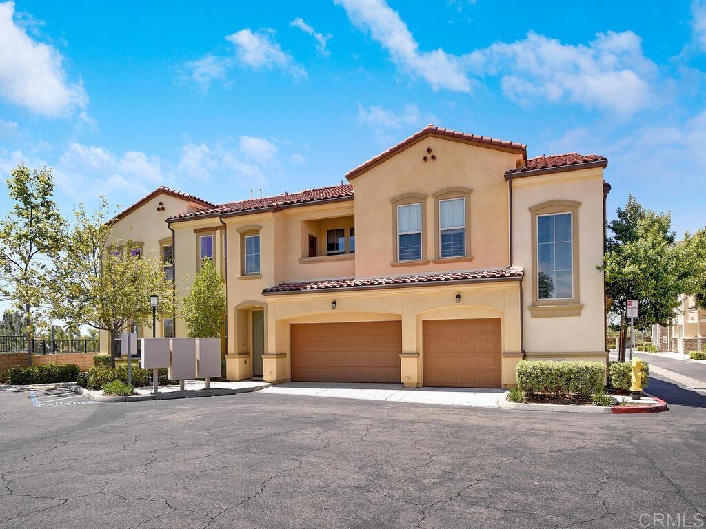 11170 Taloncrest Way, Unit 57 San Diego, CA 92126 - Photo 1 of 31 a front view of a house with a yard and garage