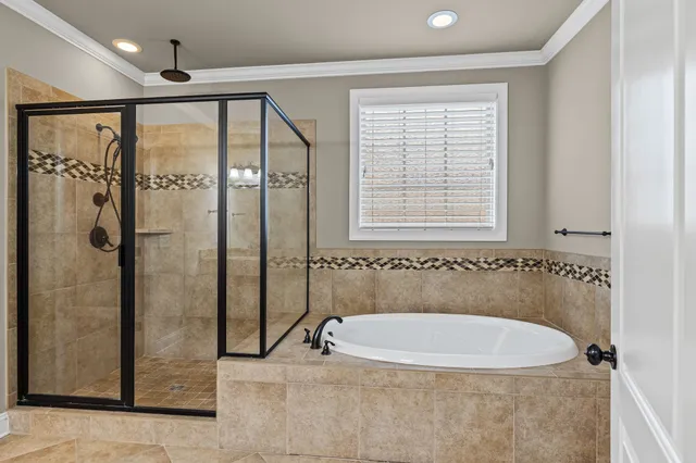 a bathroom with a bathtub and a shower