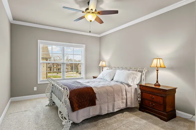 a bedroom with a bed a lamp and a chandelier