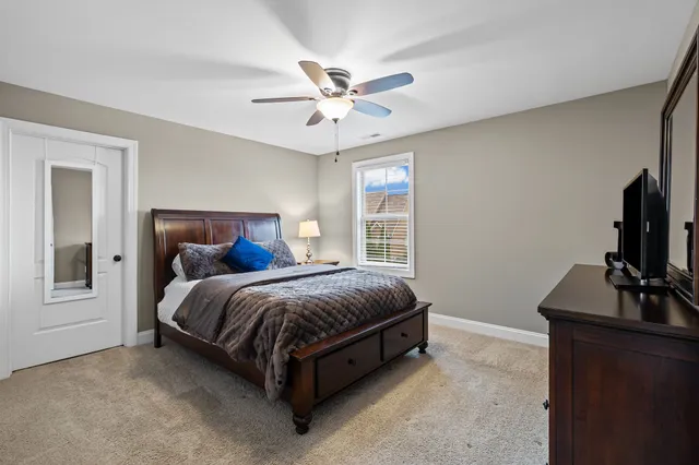 a bed room with a bed and a flat tv screen on a dresser