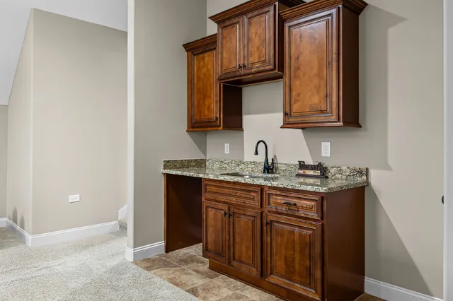 a kitchen with granite countertop a sink and cabinets