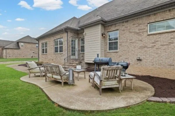 a view of a house with backyard porch and sitting area