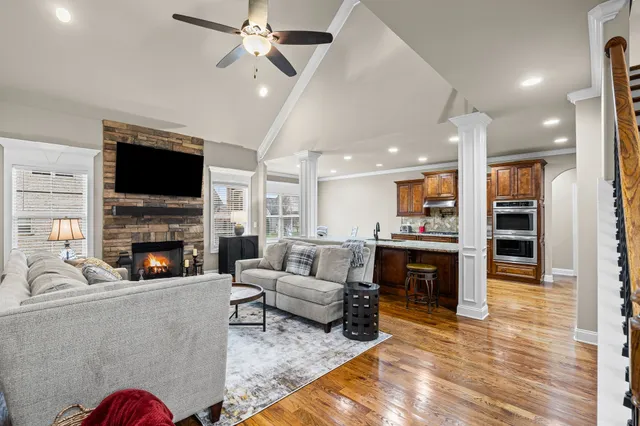 a living room with furniture a fireplace and a flat screen tv