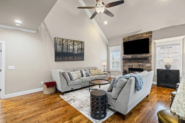 a living room with furniture fireplace and a flat screen tv