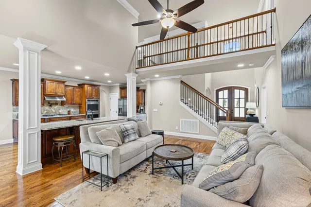 a living room with furniture ceiling fan and a rug