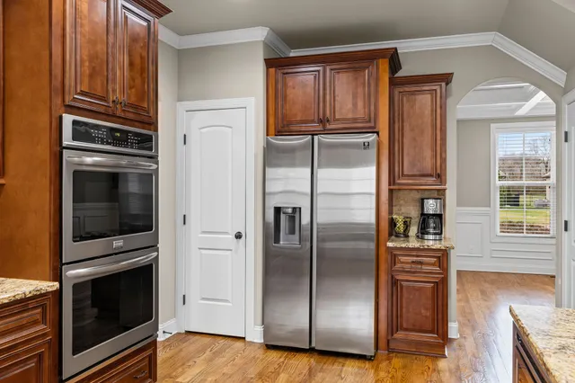 a kitchen with stainless steel appliances and refrigerator