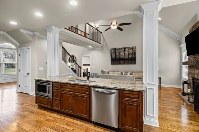 a kitchen with stainless steel appliances granite countertop a sink and stove top oven