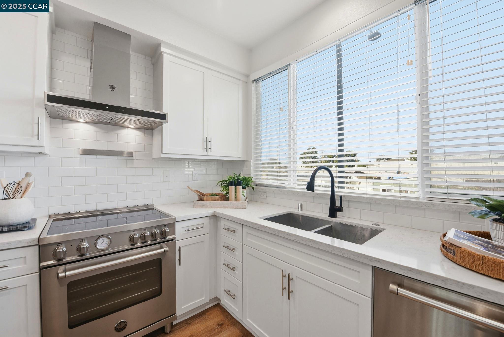 967 24th Street Oakland, CA 94607 - Photo 15 of 43 a kitchen with appliances a sink and cabinets