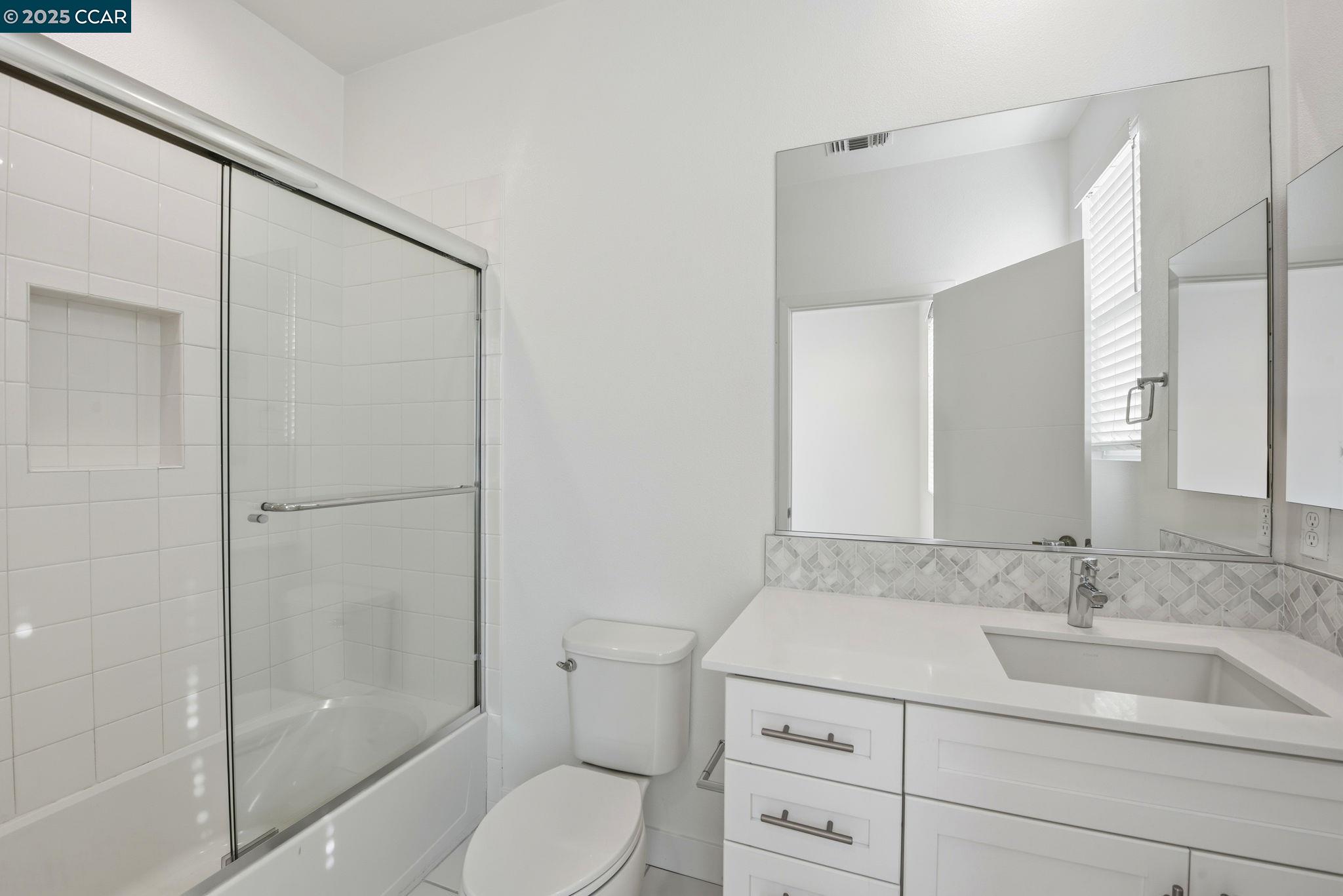 967 24th Street Oakland, CA 94607 - Photo 29 of 43 a bathroom with a sink toilet vanity and shower