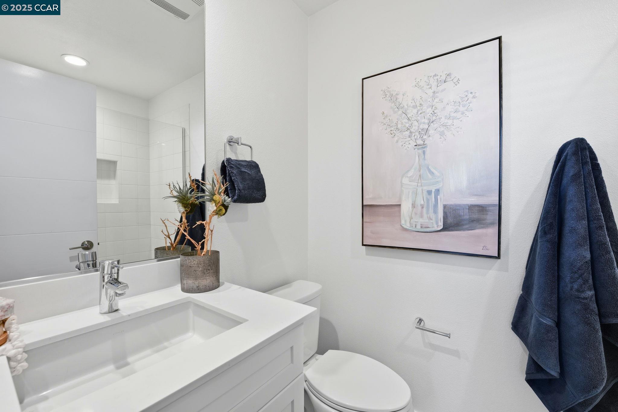 967 24th Street Oakland, CA 94607 - Photo 5 of 43 a bathroom with a toilet sink and mirror