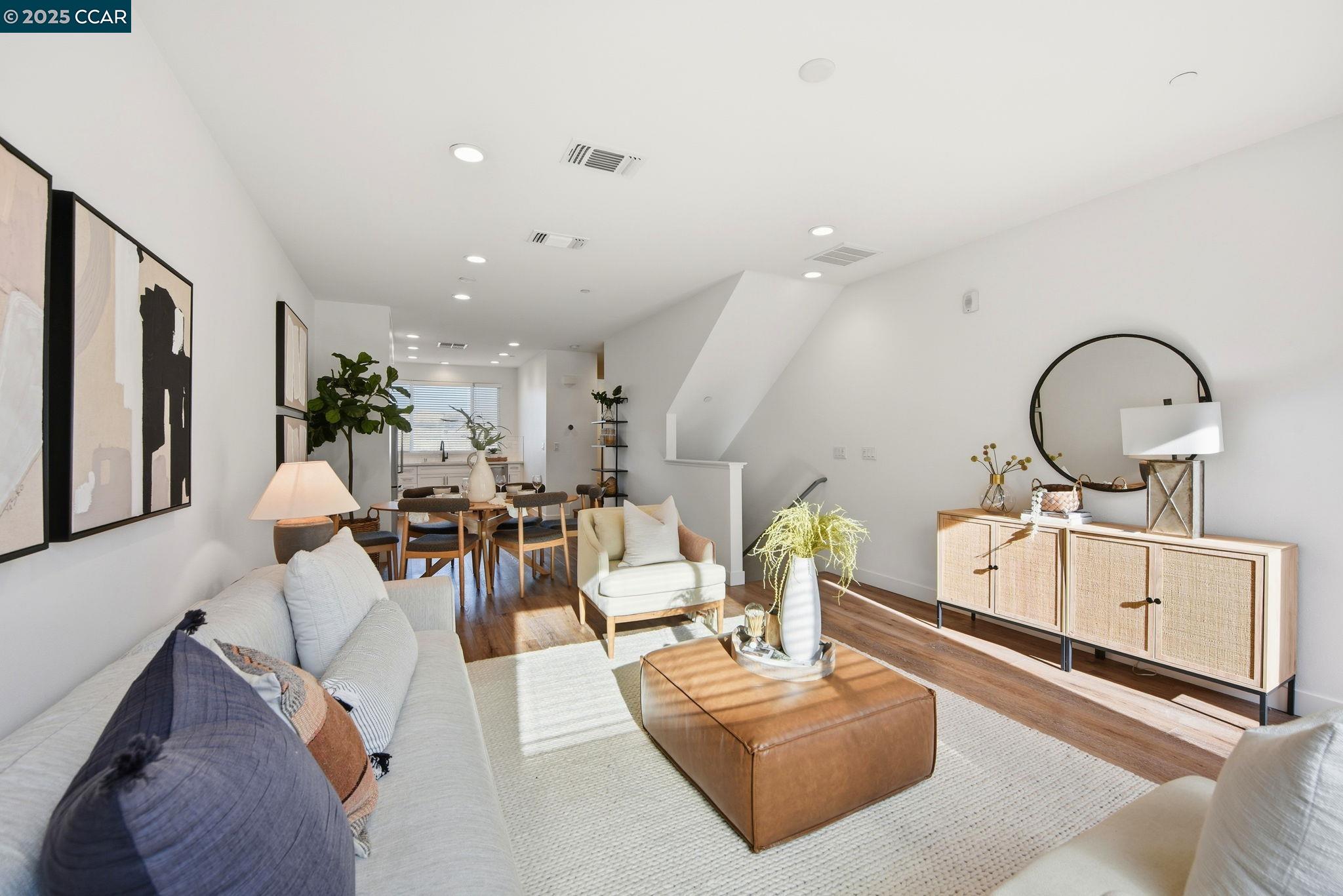 967 24th Street Oakland, CA 94607 - Photo 6 of 43 a living room with furniture a mirror and white walls