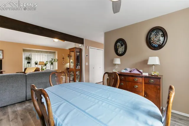 a bedroom with a bed and a lamp on dresser