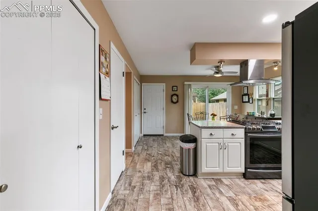 a large kitchen with a stove and a refrigerator