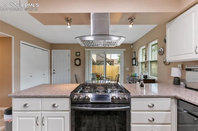 a kitchen with a stove and cabinets