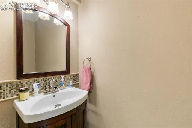 a bathroom with a sink and a mirror