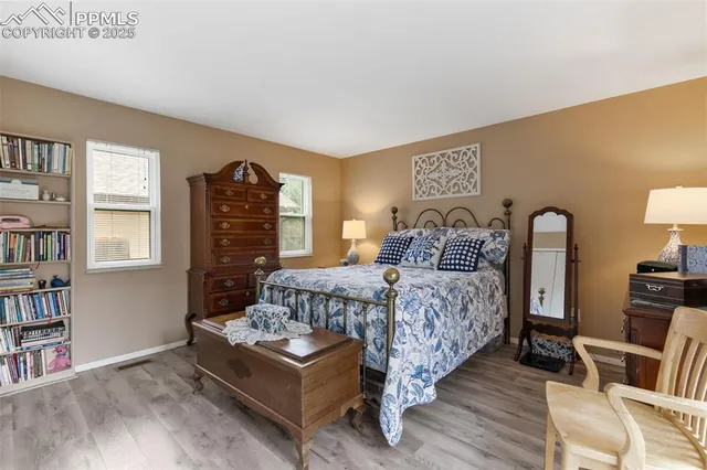 a bedroom with a bed and a book shelf