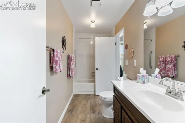 a bathroom with a sink vanity granite and a mirror