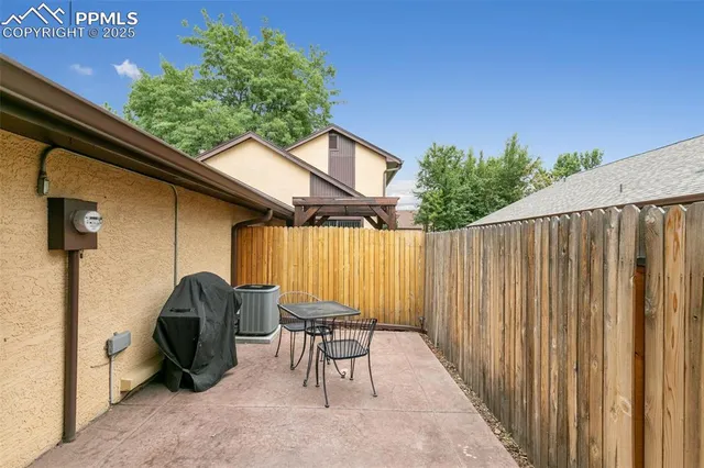 a backyard of a house with table and chairs