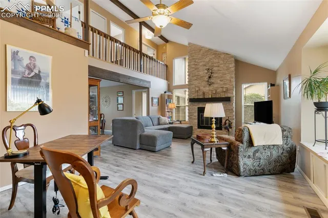 a living room with fireplace furniture and a wooden floor