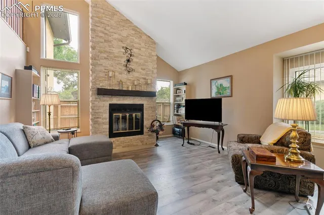 a living room with furniture a flat screen tv and a fireplace
