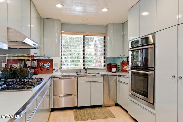 2121 Vina Del Mar Oxnard, CA 93035 - Photo 3 of 17 a kitchen with stainless steel appliances granite countertop a stove and a sink