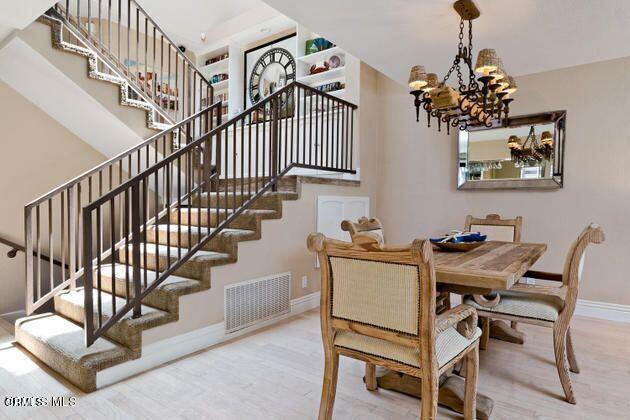 2121 Vina Del Mar Oxnard, CA 93035 - Photo 7 of 17 a view of a dining room with furniture wooden floor and a chandelier
