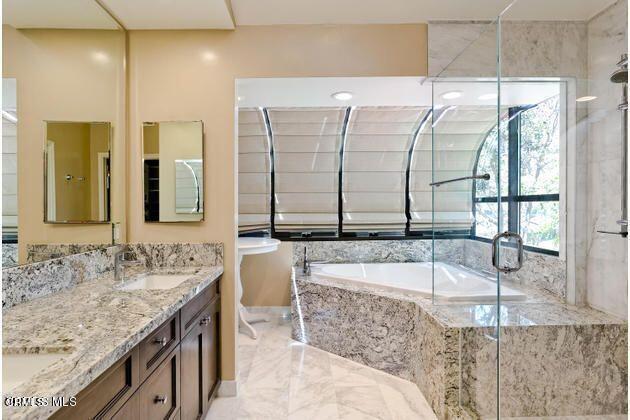 2121 Vina Del Mar Oxnard, CA 93035 - Photo 10 of 17 a bathroom with a granite countertop tub sink and mirror