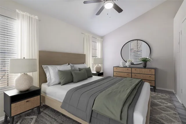 a bedroom with bed and a chandelier