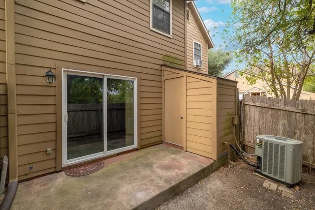a view of a house with a wooden fence