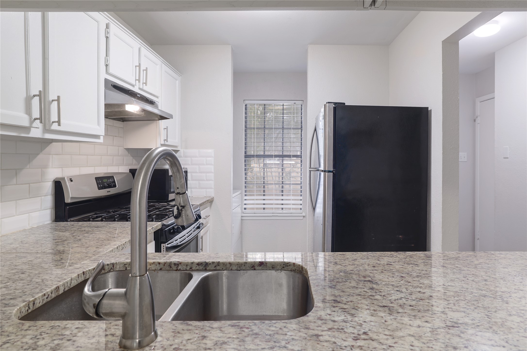 11404 Walnut Ridge Drive, Unit 4 Austin, TX 78753 - Photo 5 of 15 a kitchen with a sink and a stove top oven