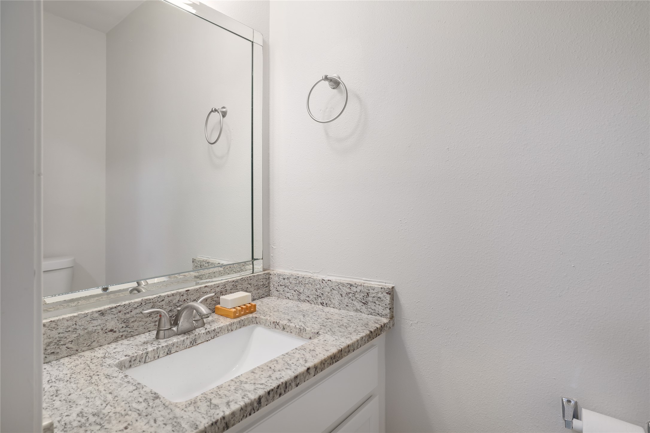 11404 Walnut Ridge Drive, Unit 4 Austin, TX 78753 - Photo 9 of 15 a bathroom with a granite countertop sink and a mirror