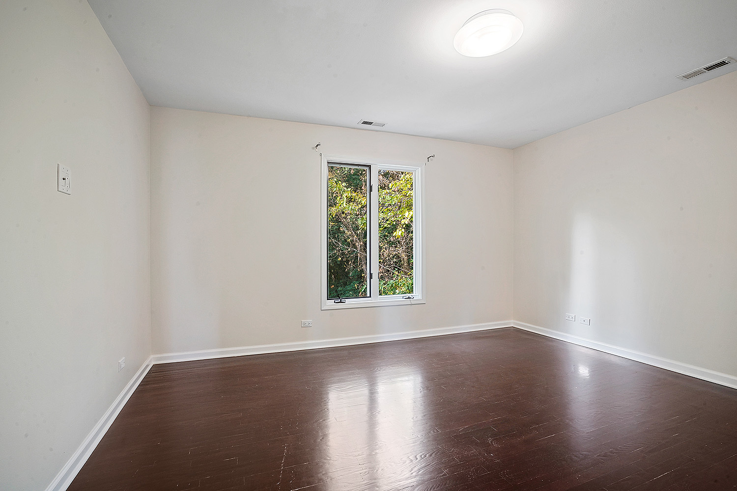 2134 Shermer Road Northbrook, IL 60062 - Photo 14 of 20 a view of an empty room with wooden floor and a window