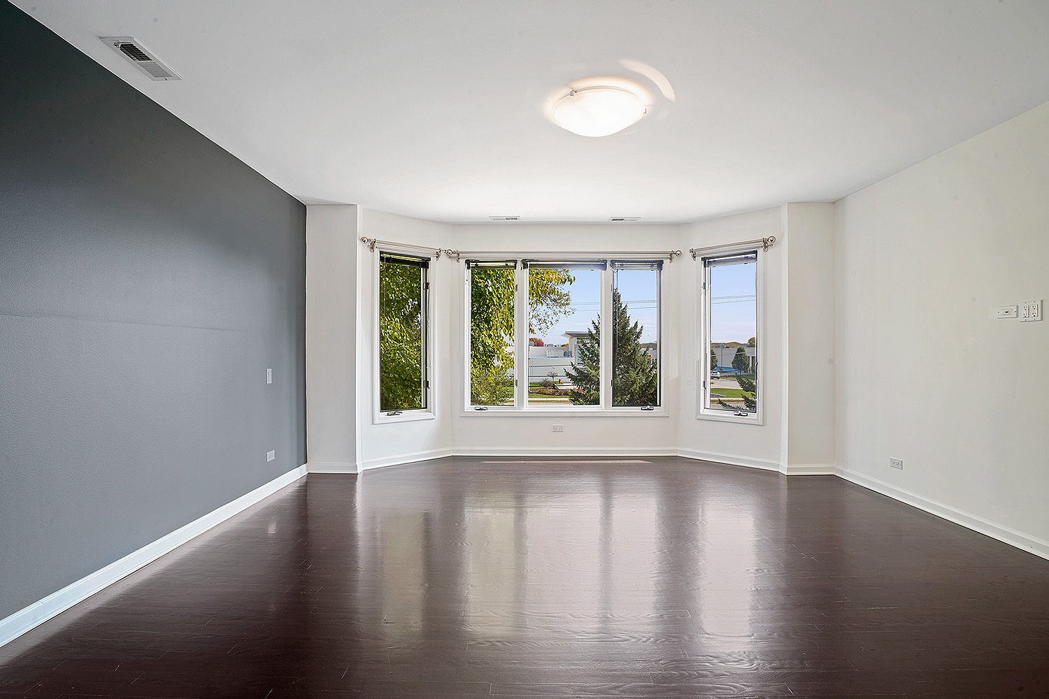 2134 Shermer Road Northbrook, IL 60062 - Photo 17 of 20 a view of an empty room with wooden floor and a window