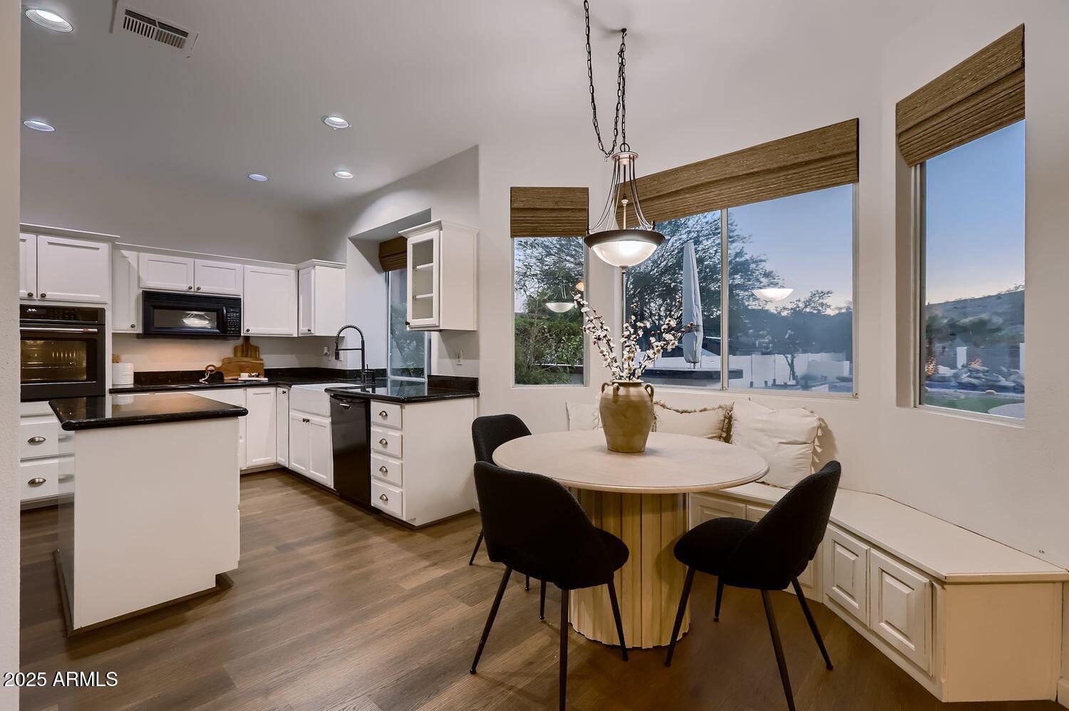 761 East Mountain Sky Avenue Phoenix, AZ 85048 - Photo 12 of 28 a kitchen with a dining table chairs and refrigerator