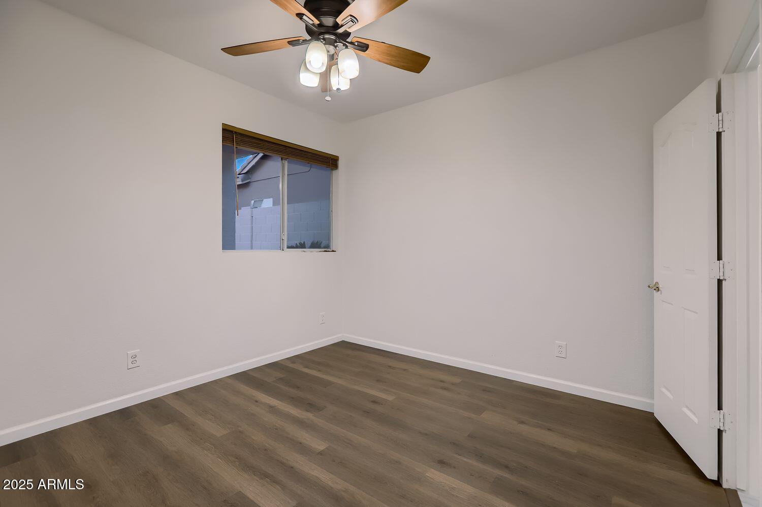 761 East Mountain Sky Avenue Phoenix, AZ 85048 - Photo 15 of 28 an empty room with wooden floor closet and fan