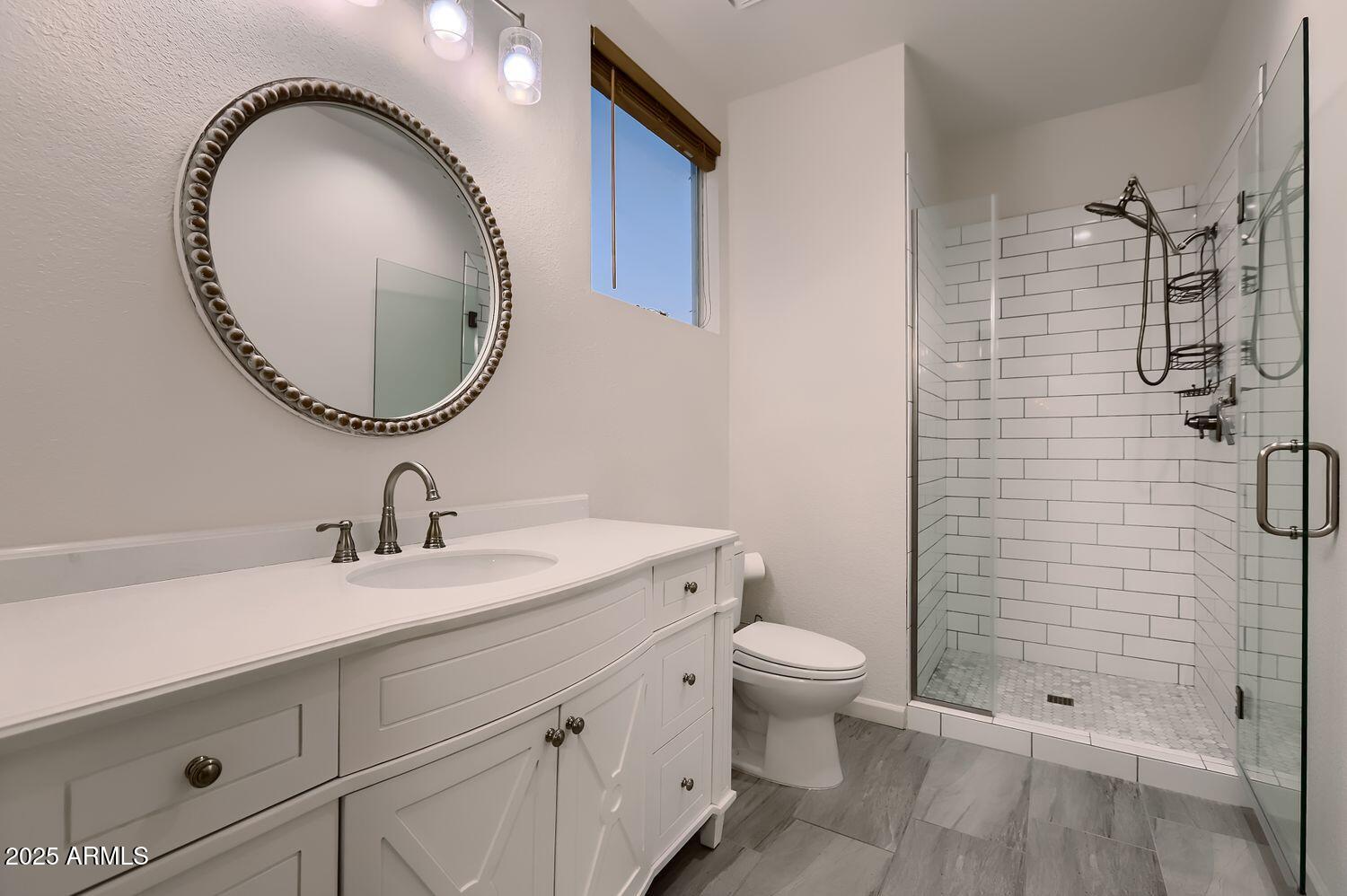 761 East Mountain Sky Avenue Phoenix, AZ 85048 - Photo 16 of 28 a bathroom with a sink a toilet and shower