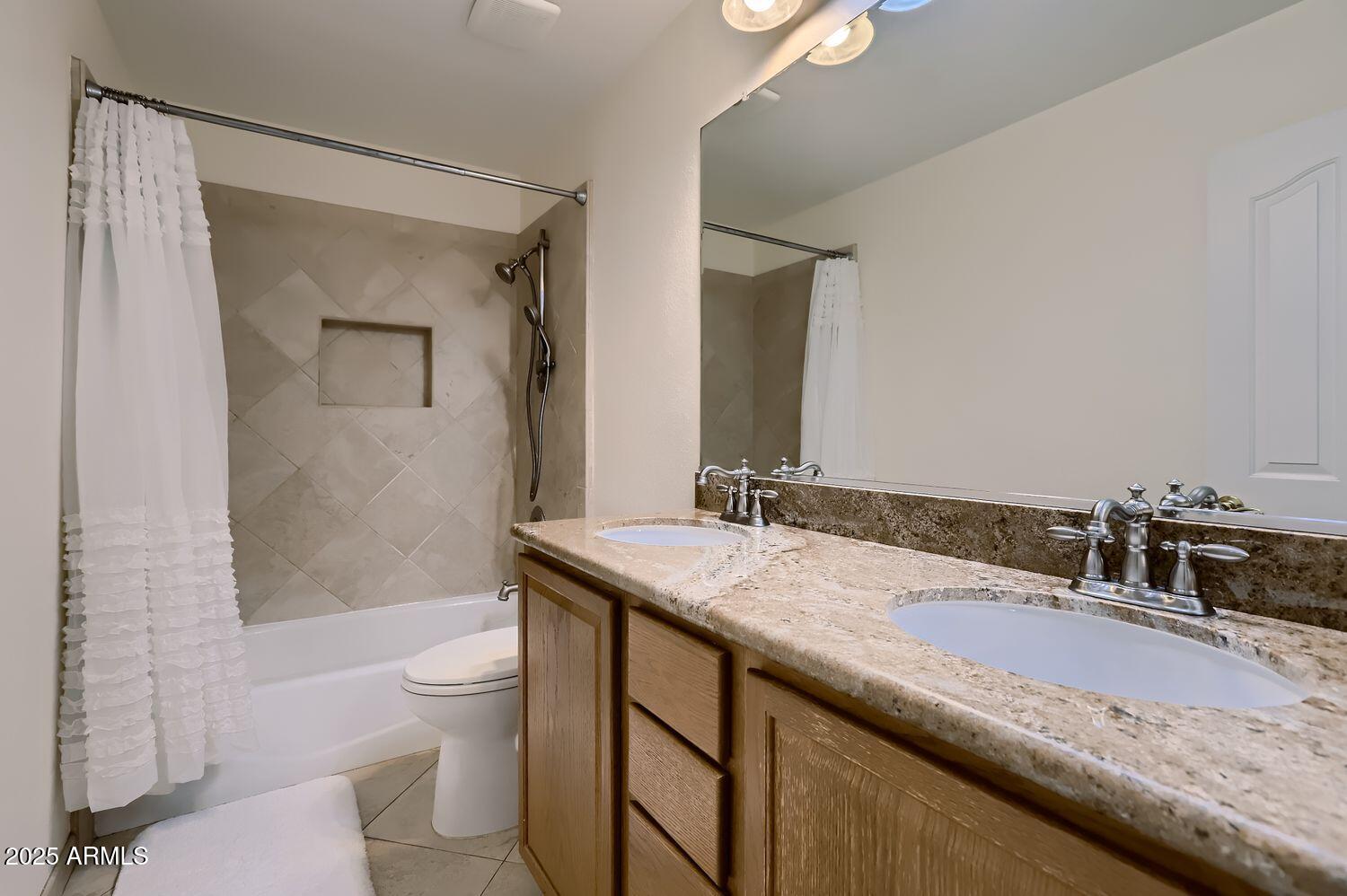 761 East Mountain Sky Avenue Phoenix, AZ 85048 - Photo 22 of 28 a bathroom with a granite countertop sink a toilet a mirror and shower