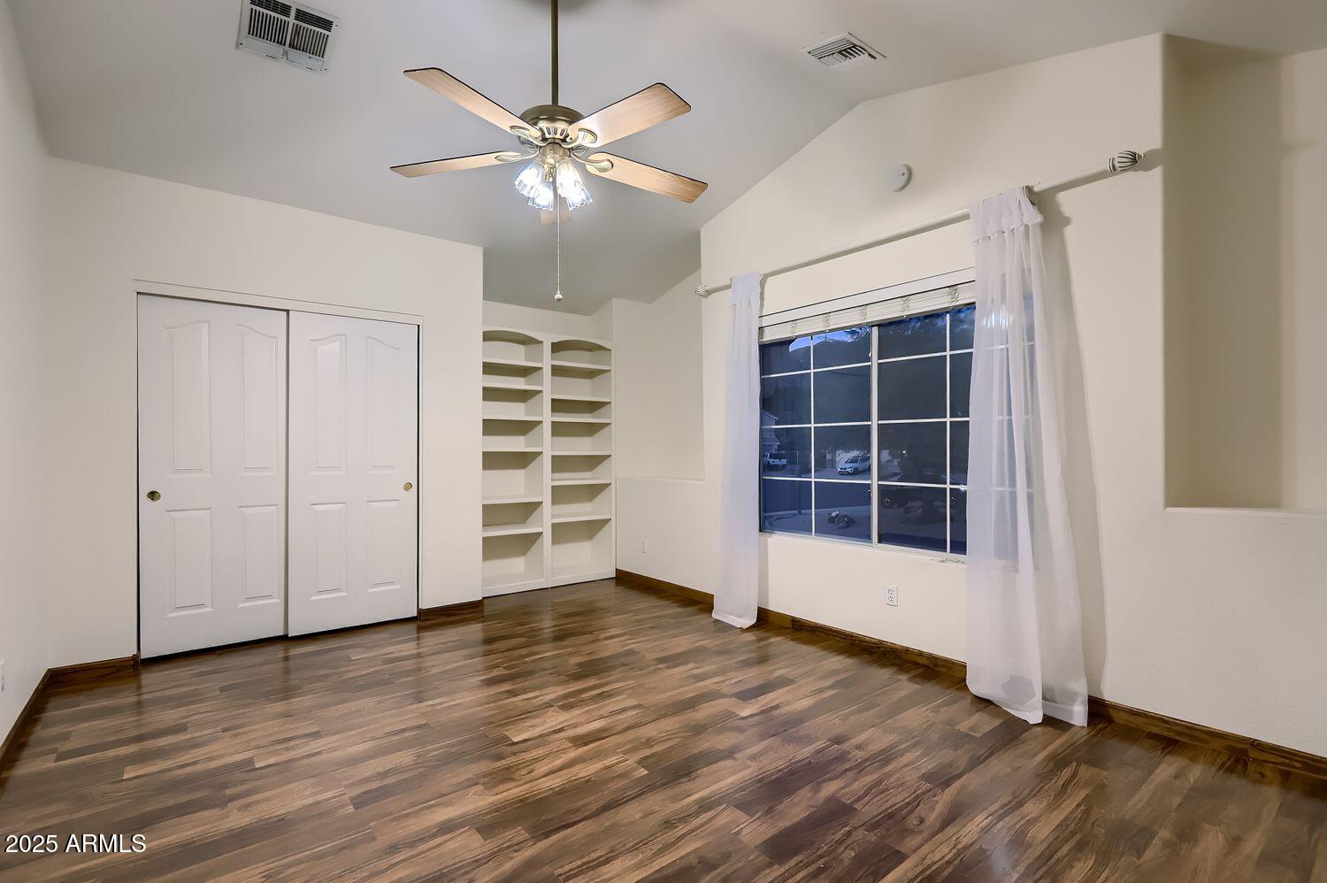 761 East Mountain Sky Avenue Phoenix, AZ 85048 - Photo 24 of 28 an empty room with wooden floor closet and windows