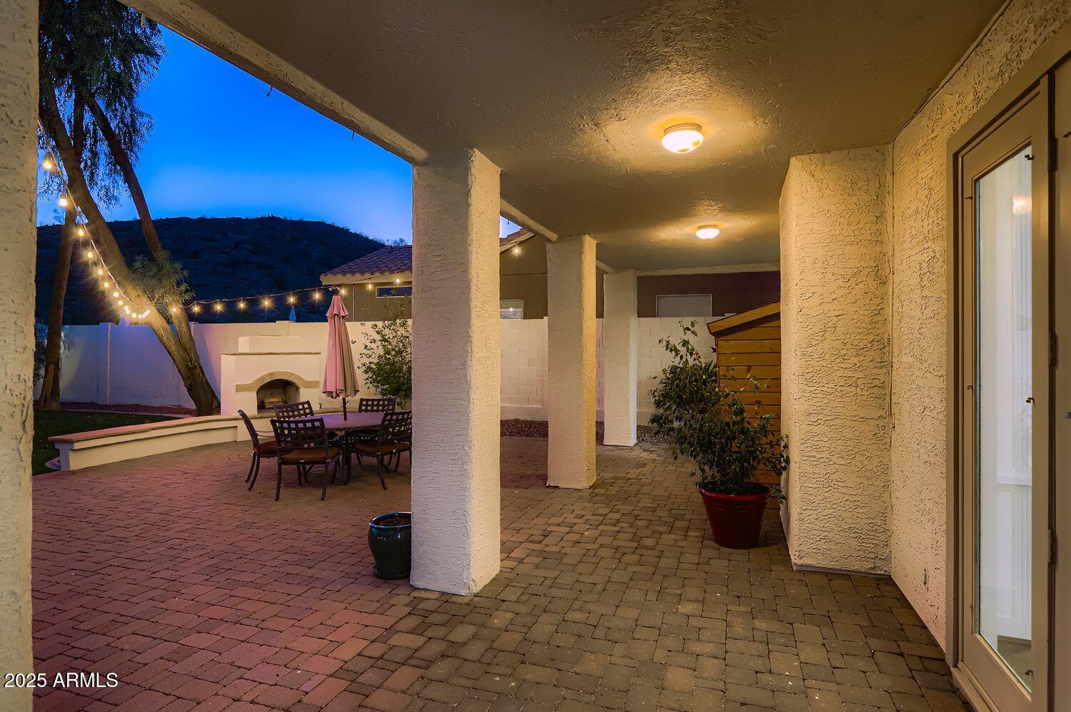 761 East Mountain Sky Avenue Phoenix, AZ 85048 - Photo 26 of 28 a view of a porch with dining table and chairs