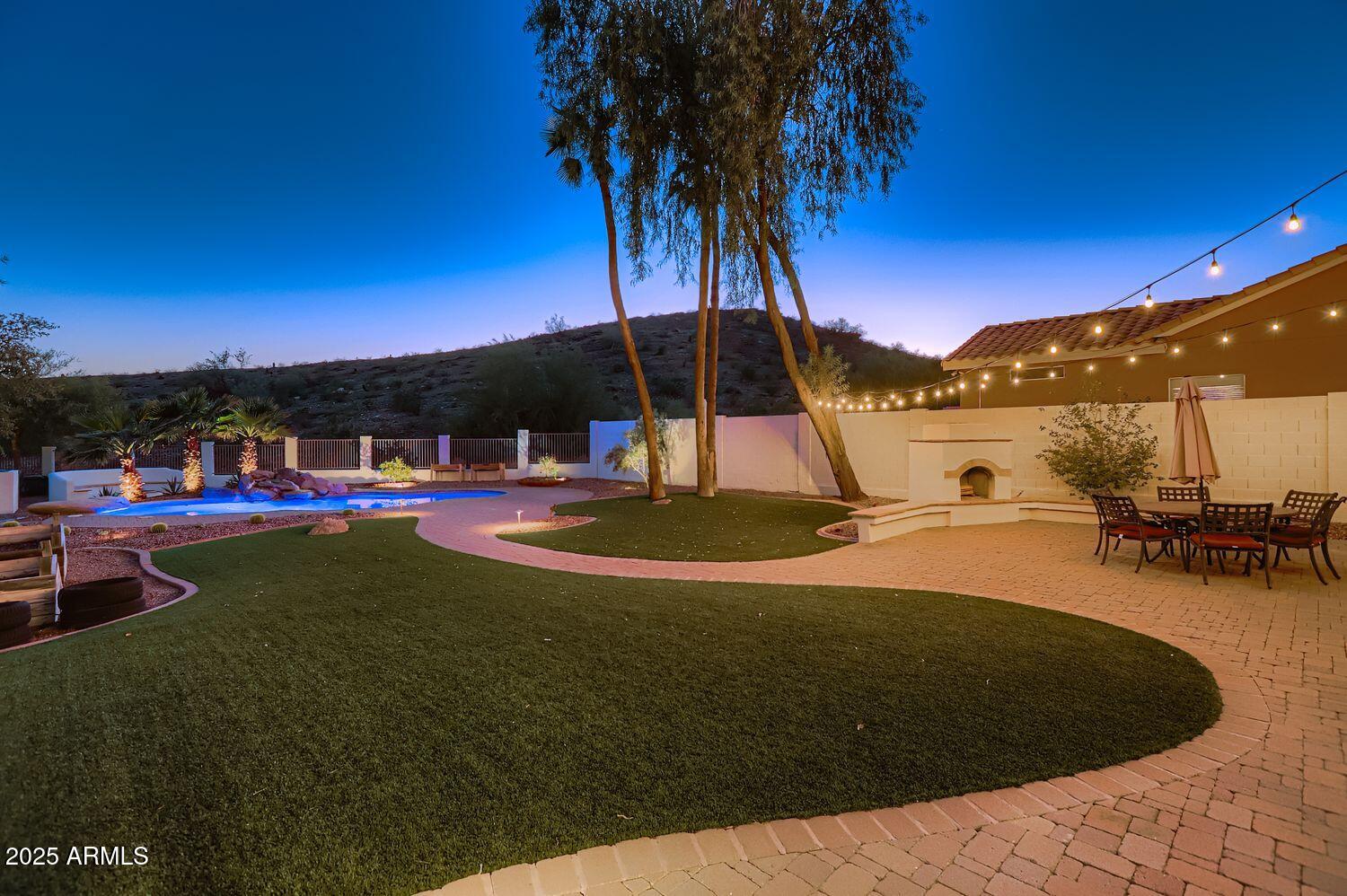 761 East Mountain Sky Avenue Phoenix, AZ 85048 - Photo 28 of 28 a view of a swimming pool with a table and chairs