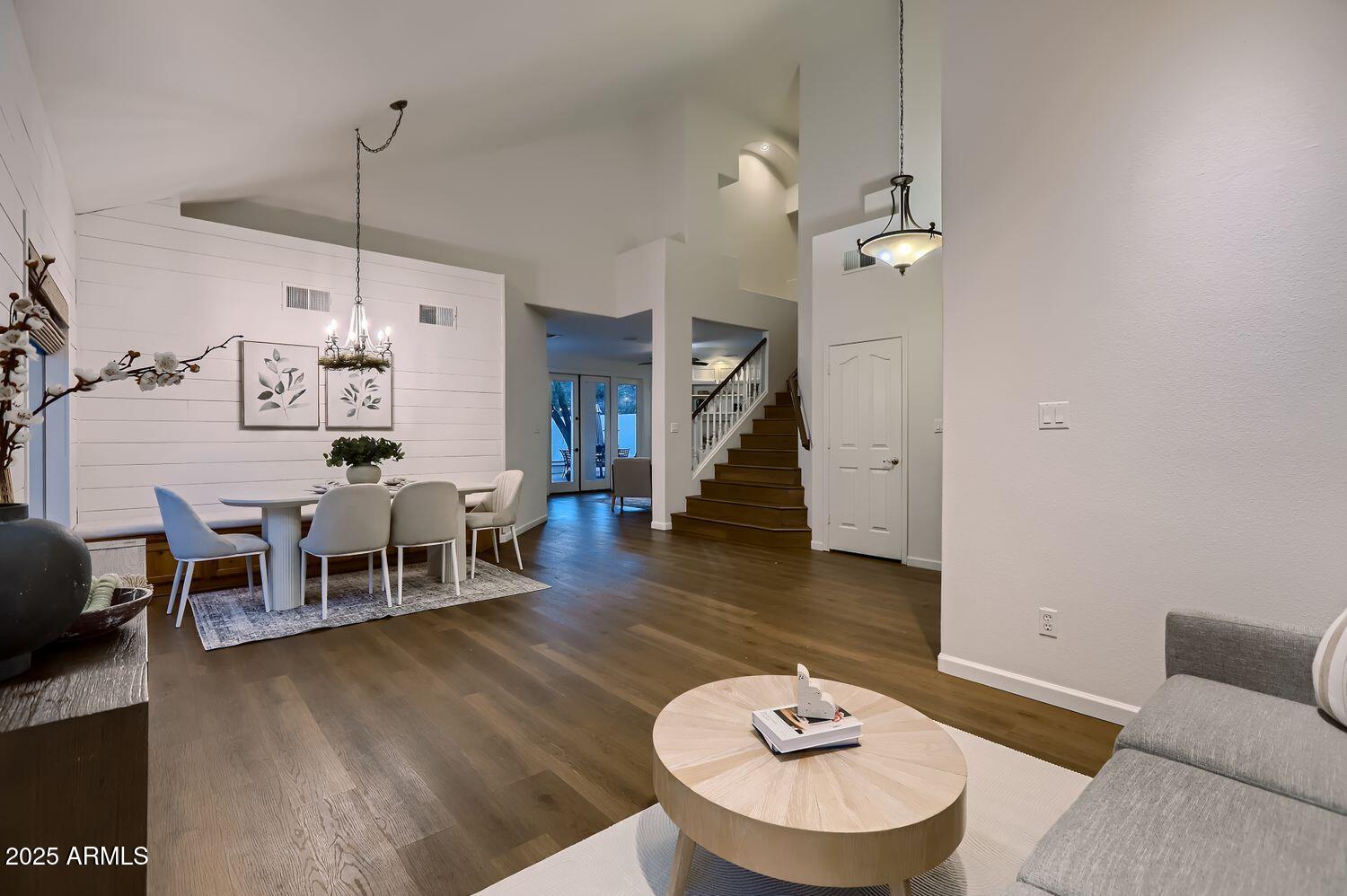 761 East Mountain Sky Avenue Phoenix, AZ 85048 - Photo 8 of 28 a living room with furniture a dining table and a chandelier