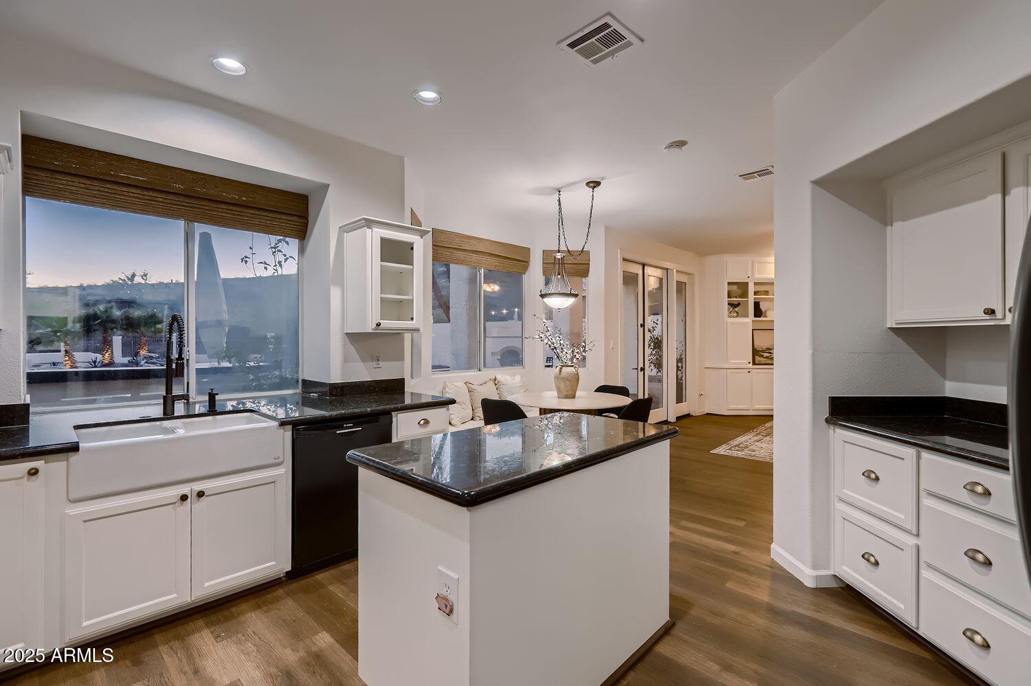 761 East Mountain Sky Avenue Phoenix, AZ 85048 - Photo 9 of 28 a kitchen with granite countertop a sink a counter space appliances and cabinets