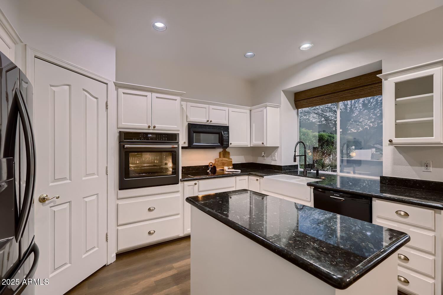 761 East Mountain Sky Avenue Phoenix, AZ 85048 - Photo 10 of 28 a kitchen with granite countertop a sink a counter top space stainless steel appliances and cabinets