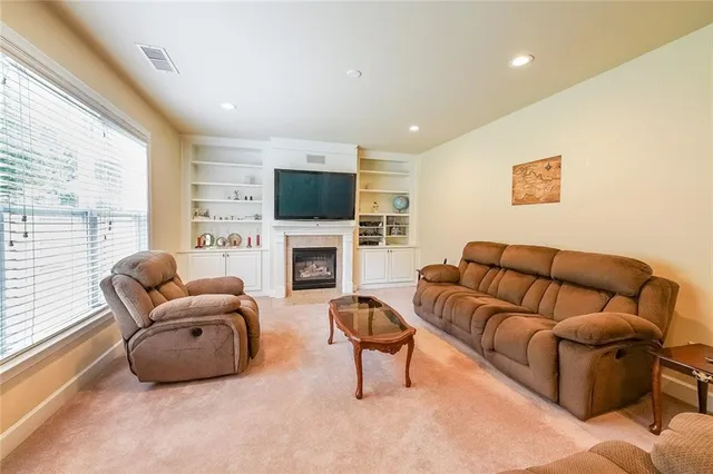 a room with stainless steel appliances wooden floor and a large window