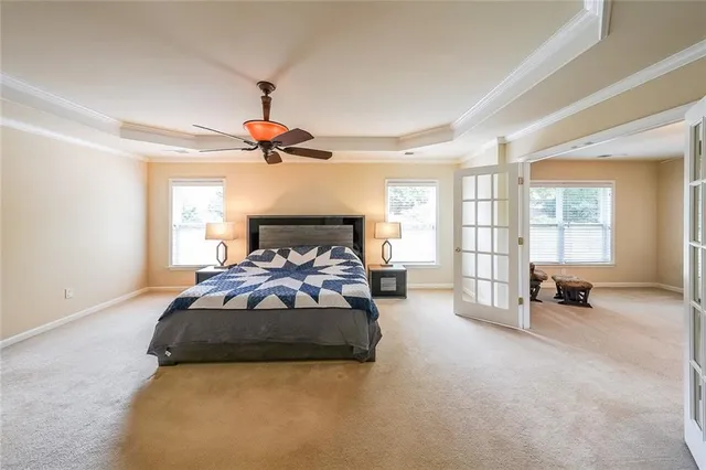 a bedroom with a bed and a chandelier