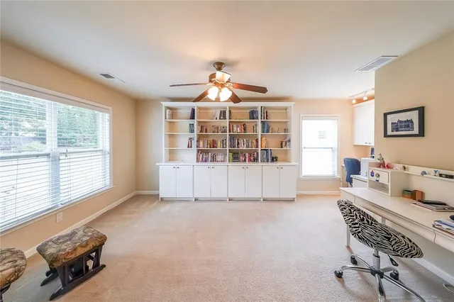 a living room with furniture cabinets and a book shelf