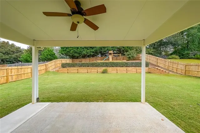 a view of a field with trees in the background