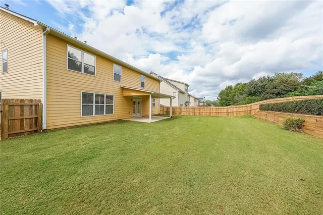 an aerial view of a house with a yard and swimming pool